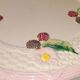 Footed dessert plate in barbotine porcelain, marked FG.
