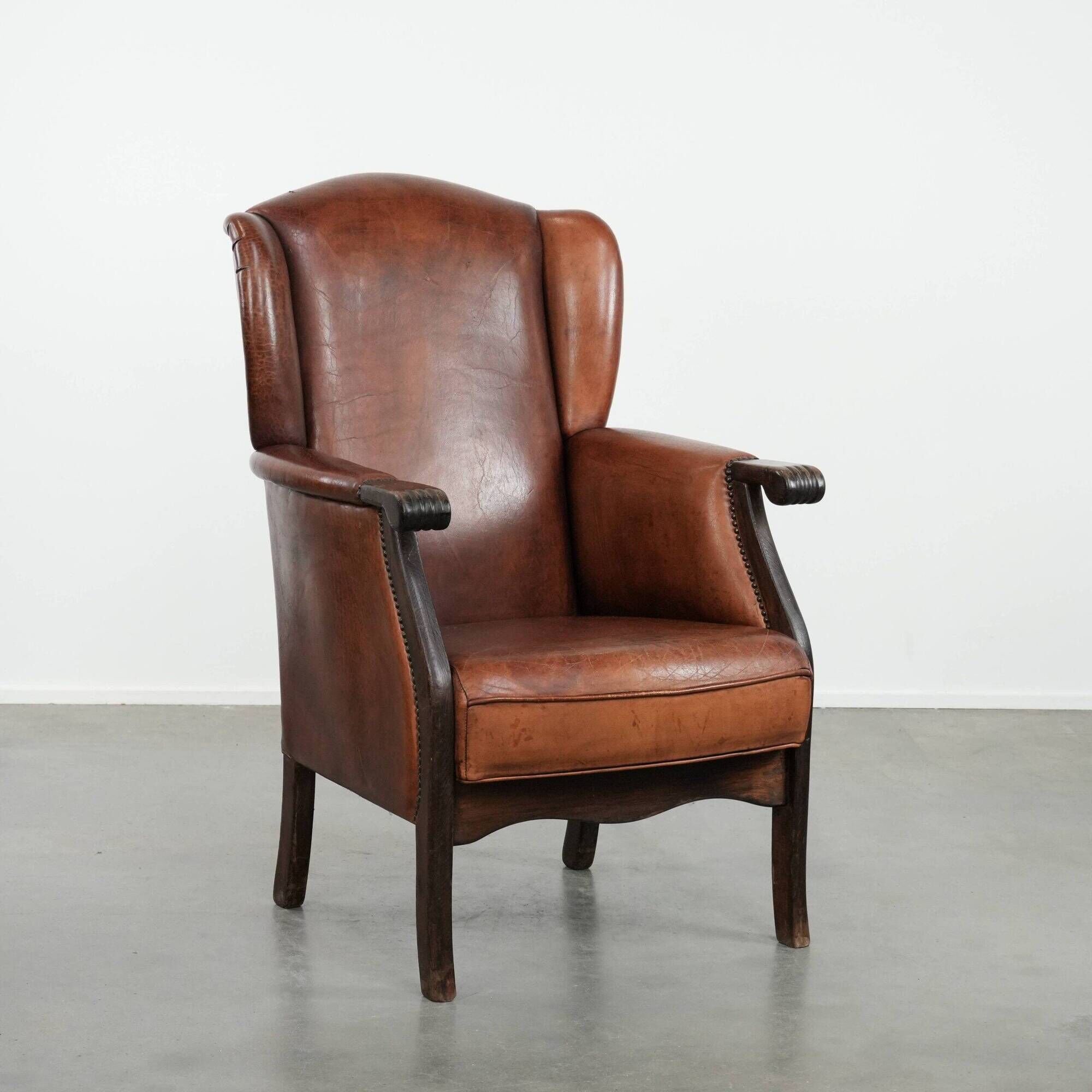 Classic vintage wingback chair in sheepskin and wood