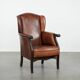 Classic vintage wingback chair in sheepskin and wood