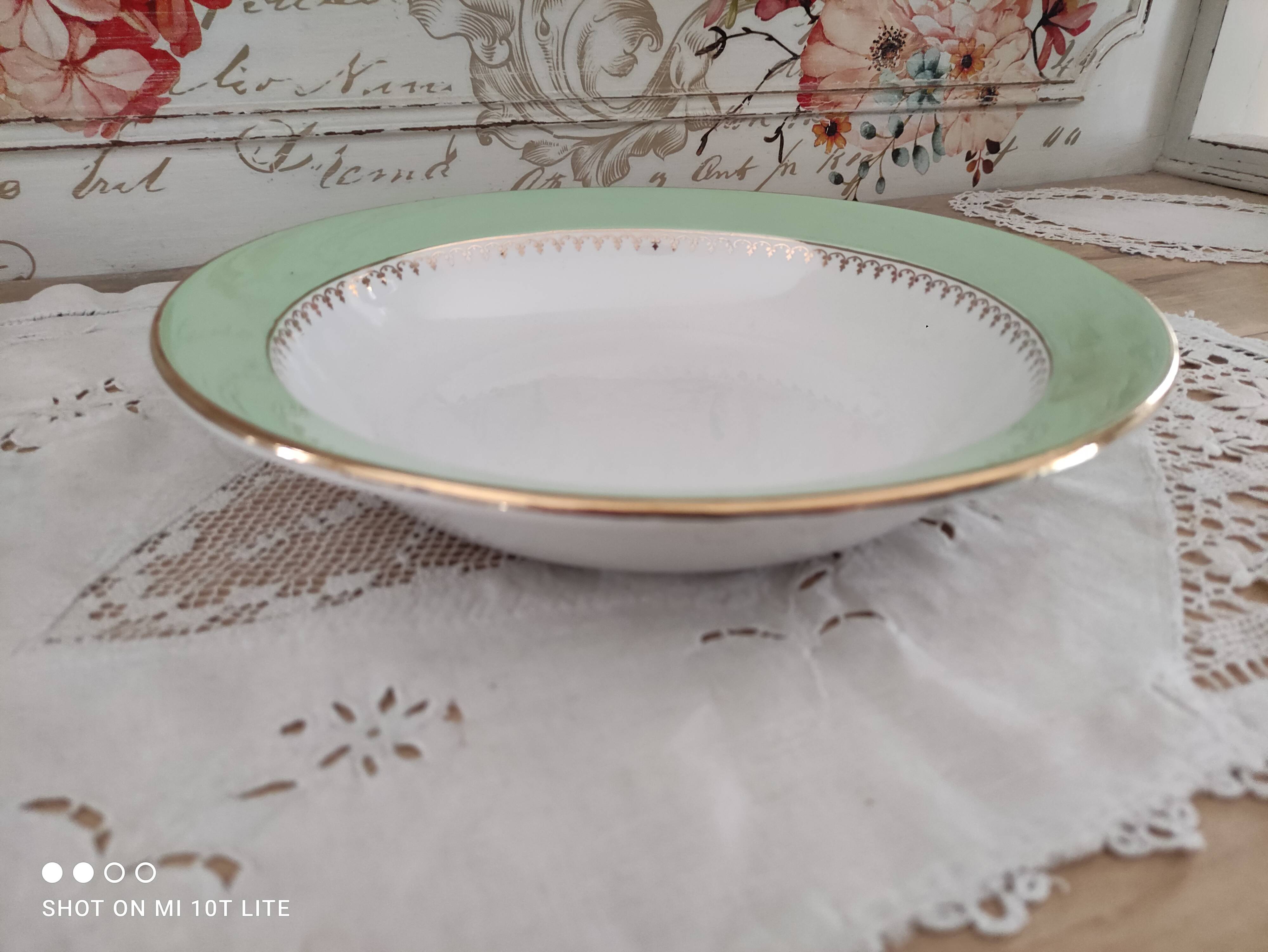 Round hollow plate in water green with a golden frieze, Cafés Lemaire.