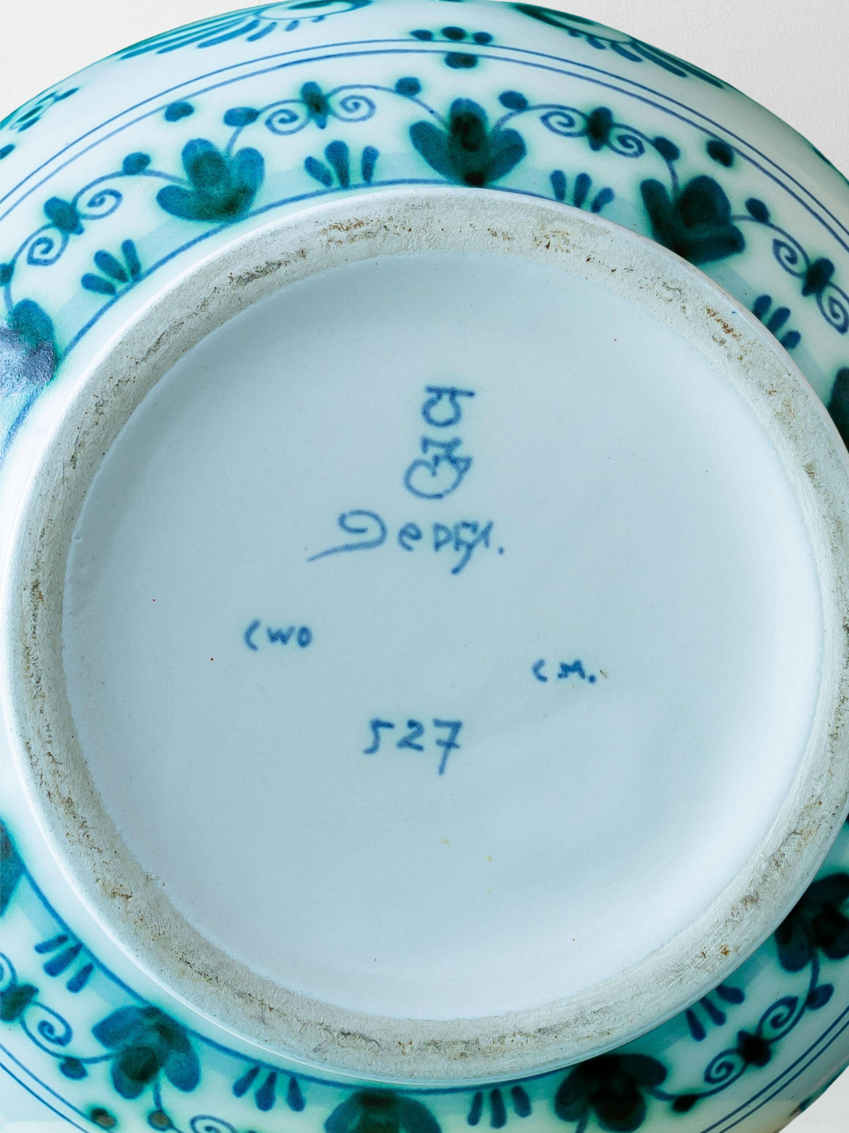 Royal Delft blue-green ceramic table lamp with pink jacquard peacock shade.