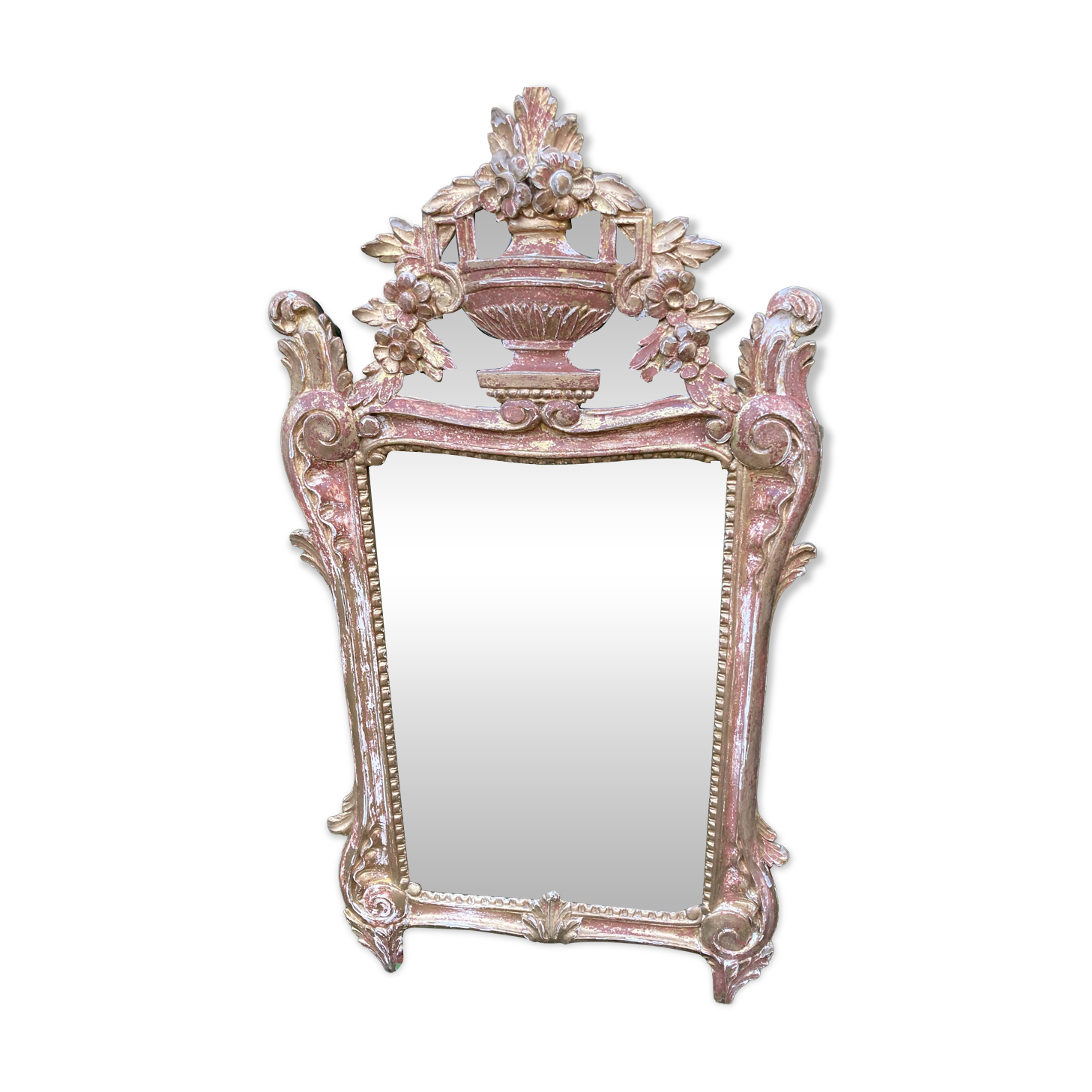 Mirror above a wooden and gilded stucco fireplace in the style of the 18th century.
