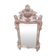 Mirror above a wooden and gilded stucco fireplace in the style of the 18th century.