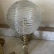 Pair of neoclassical wall sconces in twisted brass and ribbed glass.
