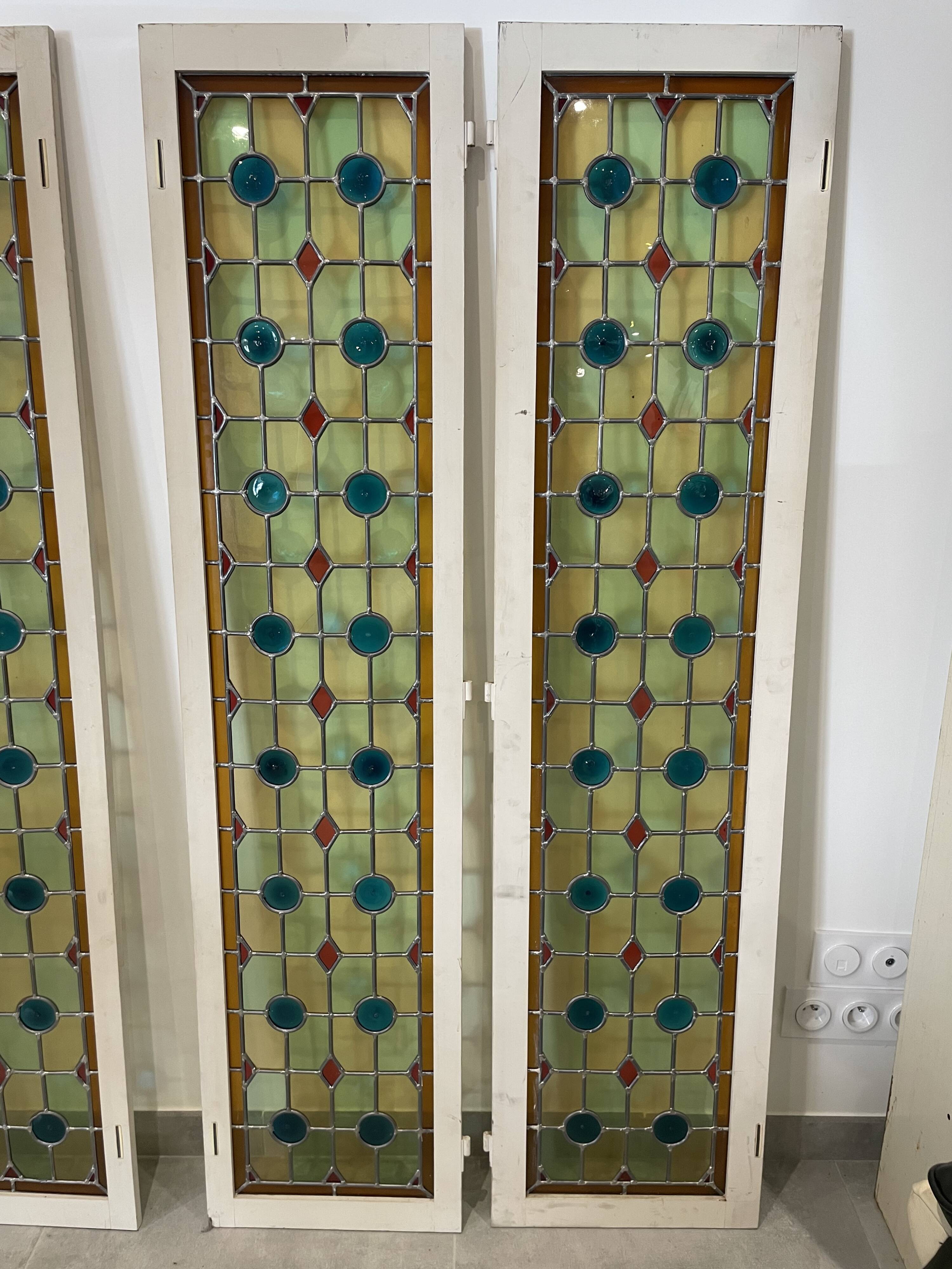 4 vintage faux stained glass panels that can form a screen or a partition