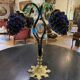 Table lamp with four light arms and globes shaped like bunches of grapes.