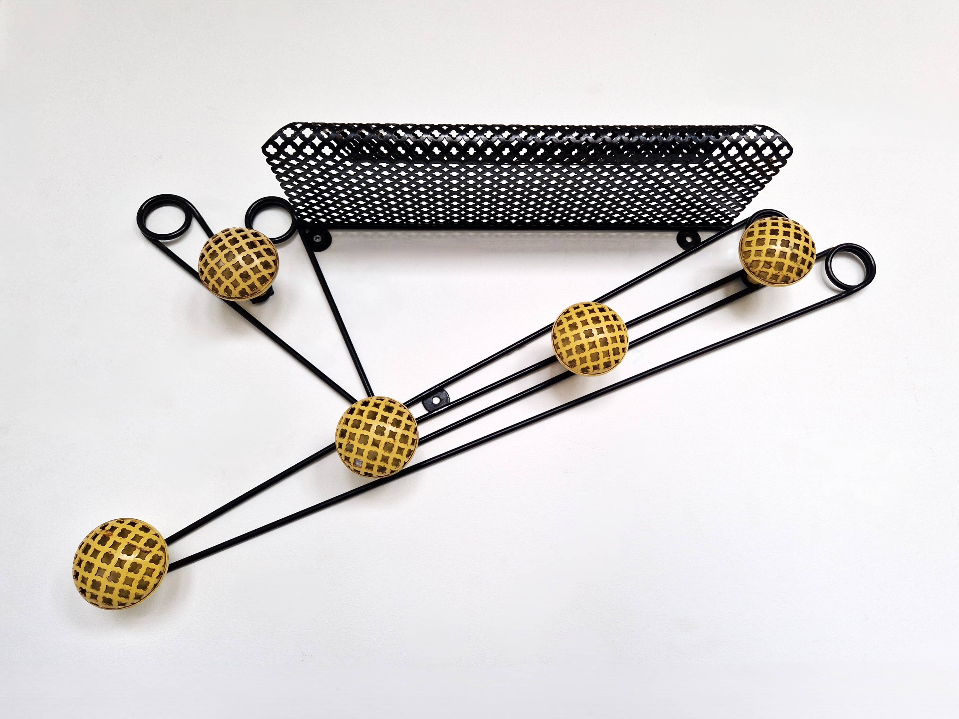 Black and yellow wall coat rack, France