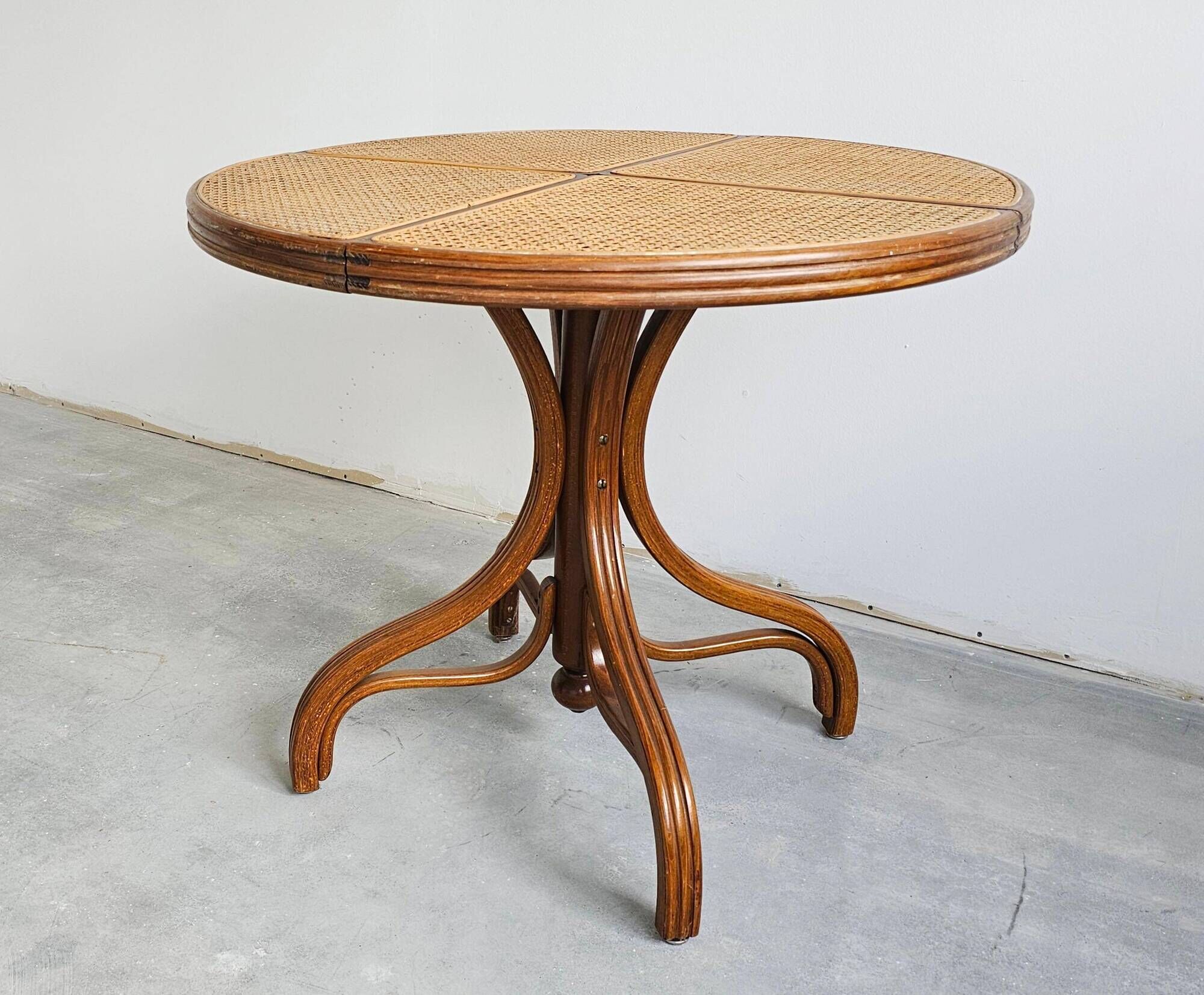 Round dining table in curved wood with a rattan top by Mundus, 1960s.