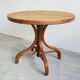 Round dining table in curved wood with a rattan top by Mundus, 1960s.