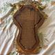 Antique rococo mirror with putti, gilded carved wood and stucco frame, 19th century.