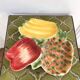 Aperitif server with fruit bowl and raw vegetables.