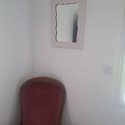 Mid-20th century rectangular wall mirror with a powder pink frame.