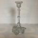 Thick moulded glass candlestick with fish and flowers.