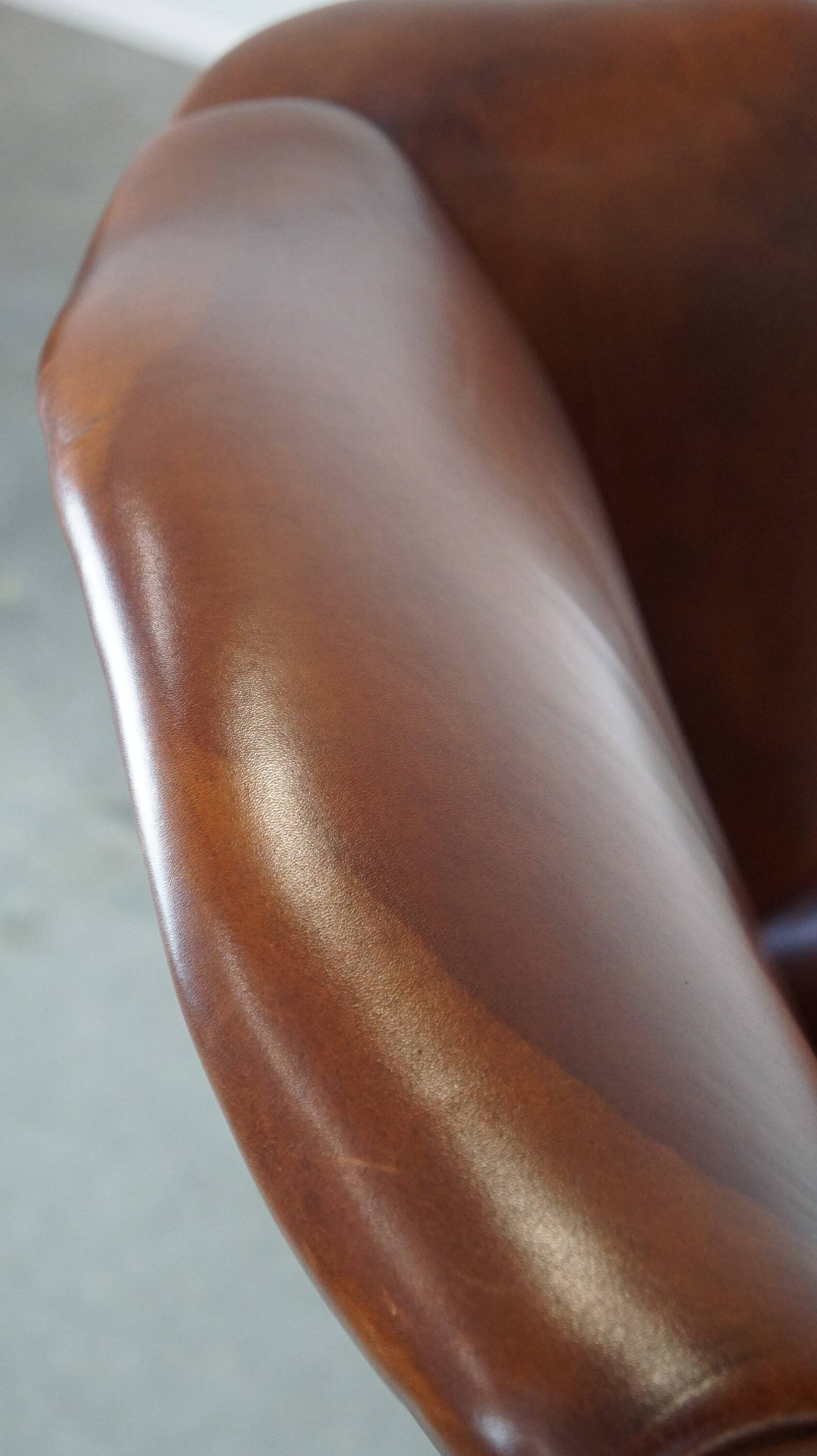 Fauteuil à oreilles en cuir de vachette cognac