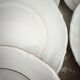 12 dessert plates in porcelain with double gold trim.
