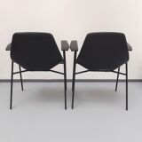 Pair of armchairs, Tonneau model, in black skai by Pierre Guariche, 60s