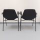 Paire de fauteuils modèle Tonneau, en skaï noir par Pierre Guariche, années 60