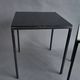 Pair of modernist nesting tables in black metal and white and black opaline 1960.