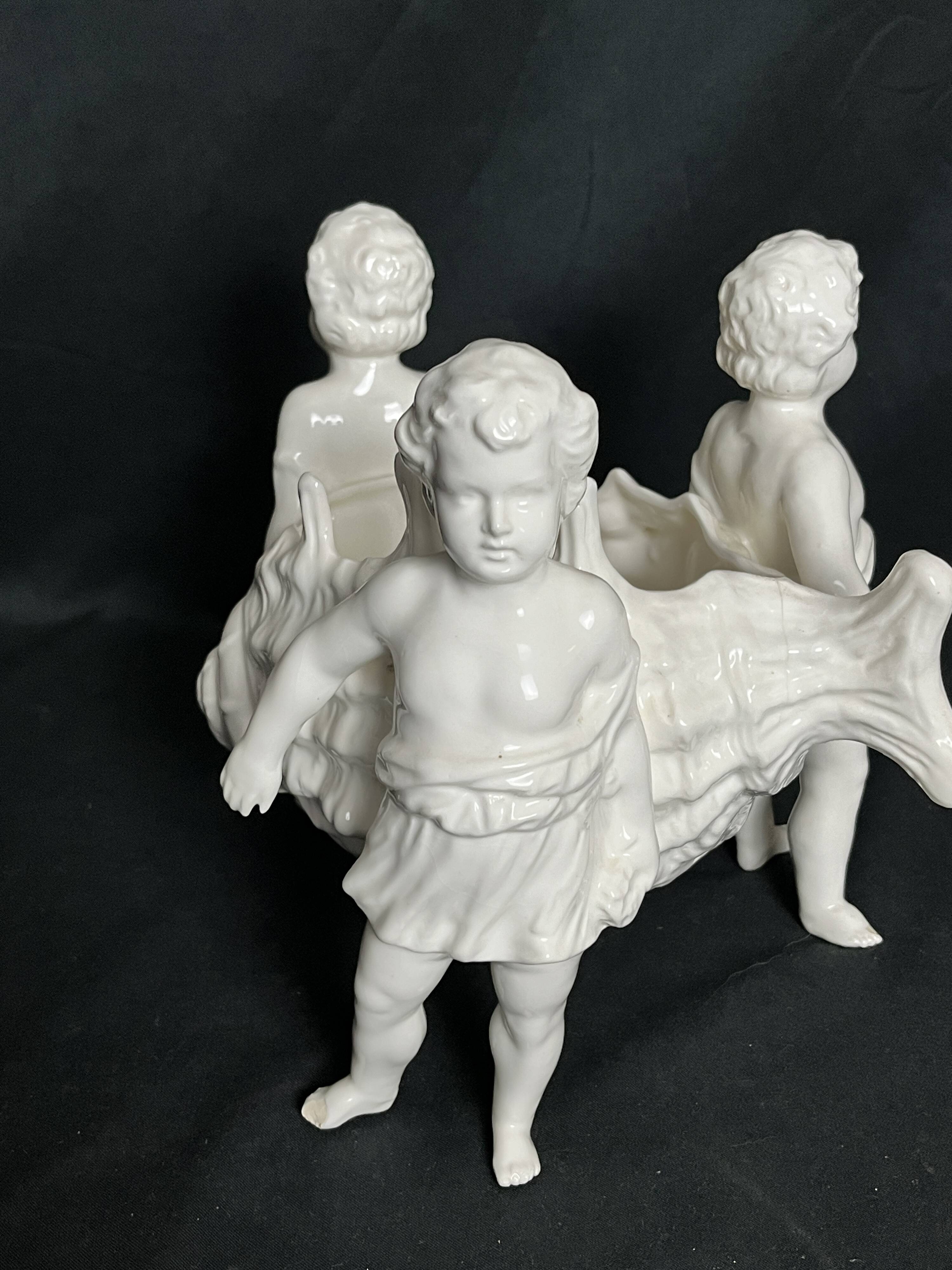 Porcelain, centerpiece with candle holder decorated with putti, 20th century