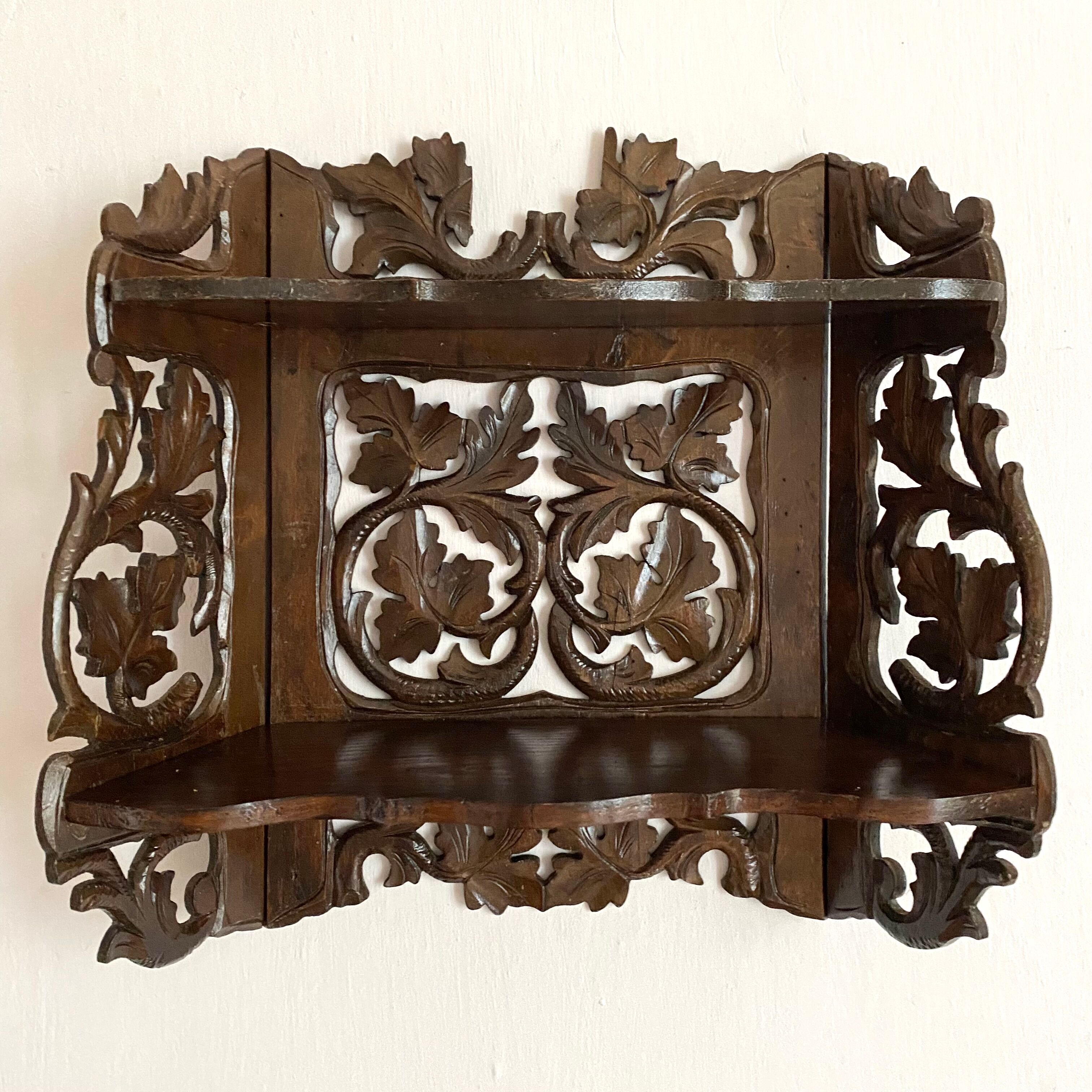 Carved wooden wall shelf