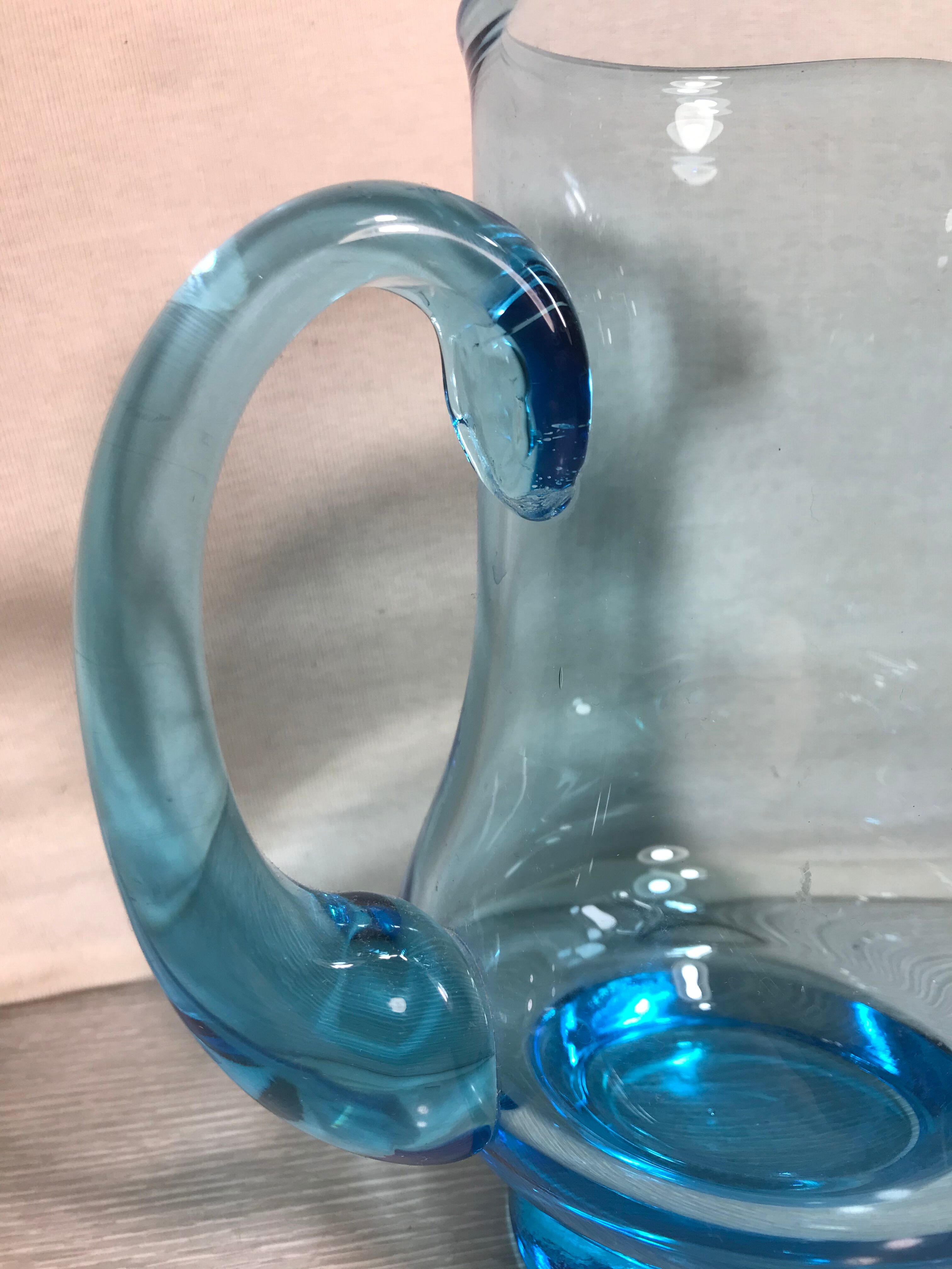 Old blue blown glass pitcher with vintage handle