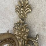 Adjustable wall light in brass and gold metal.