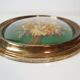 Domed glass frame with its bouquet of dried flowers