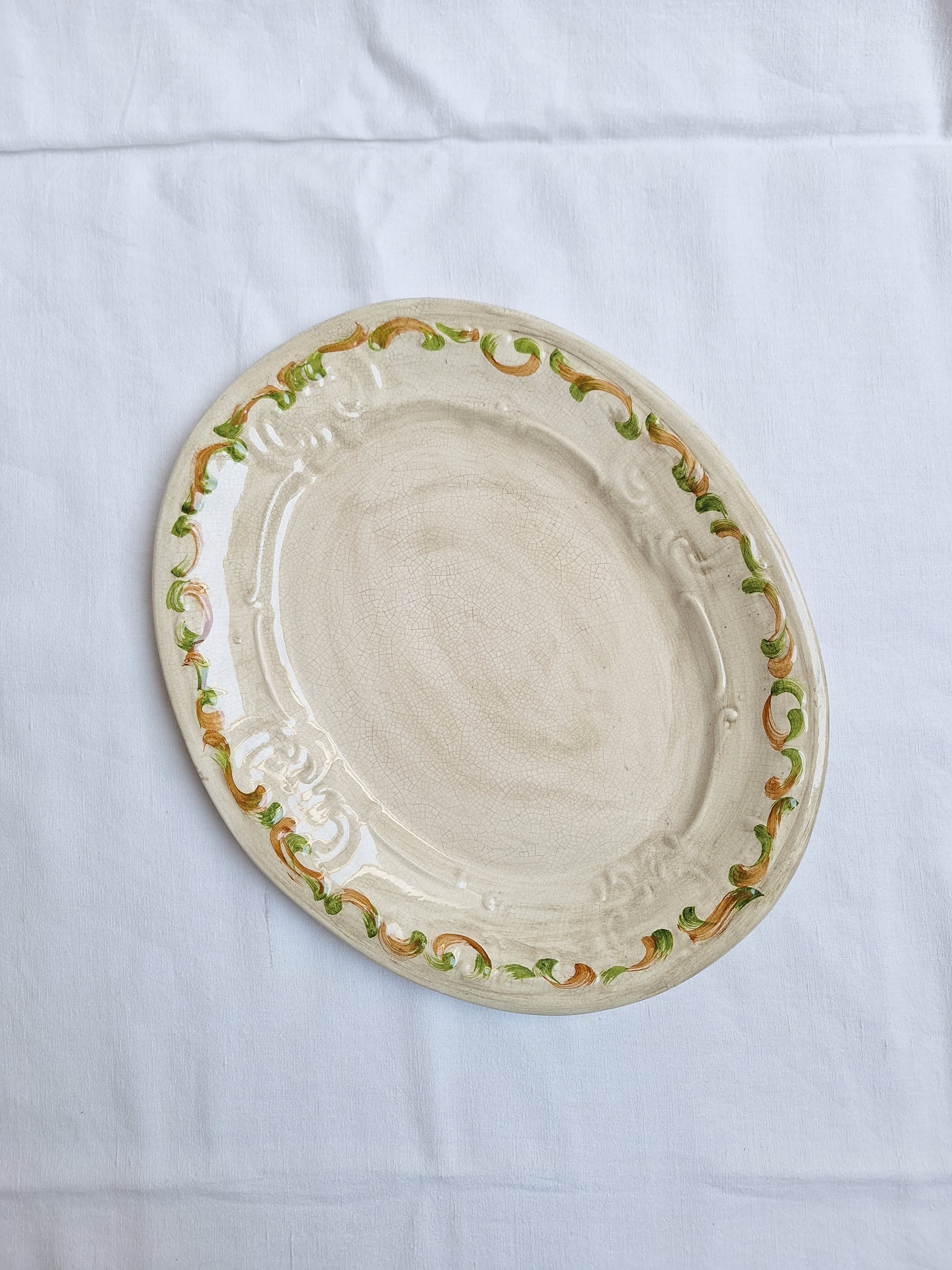 Oval plate, hand-painted meat platter in orange and green.