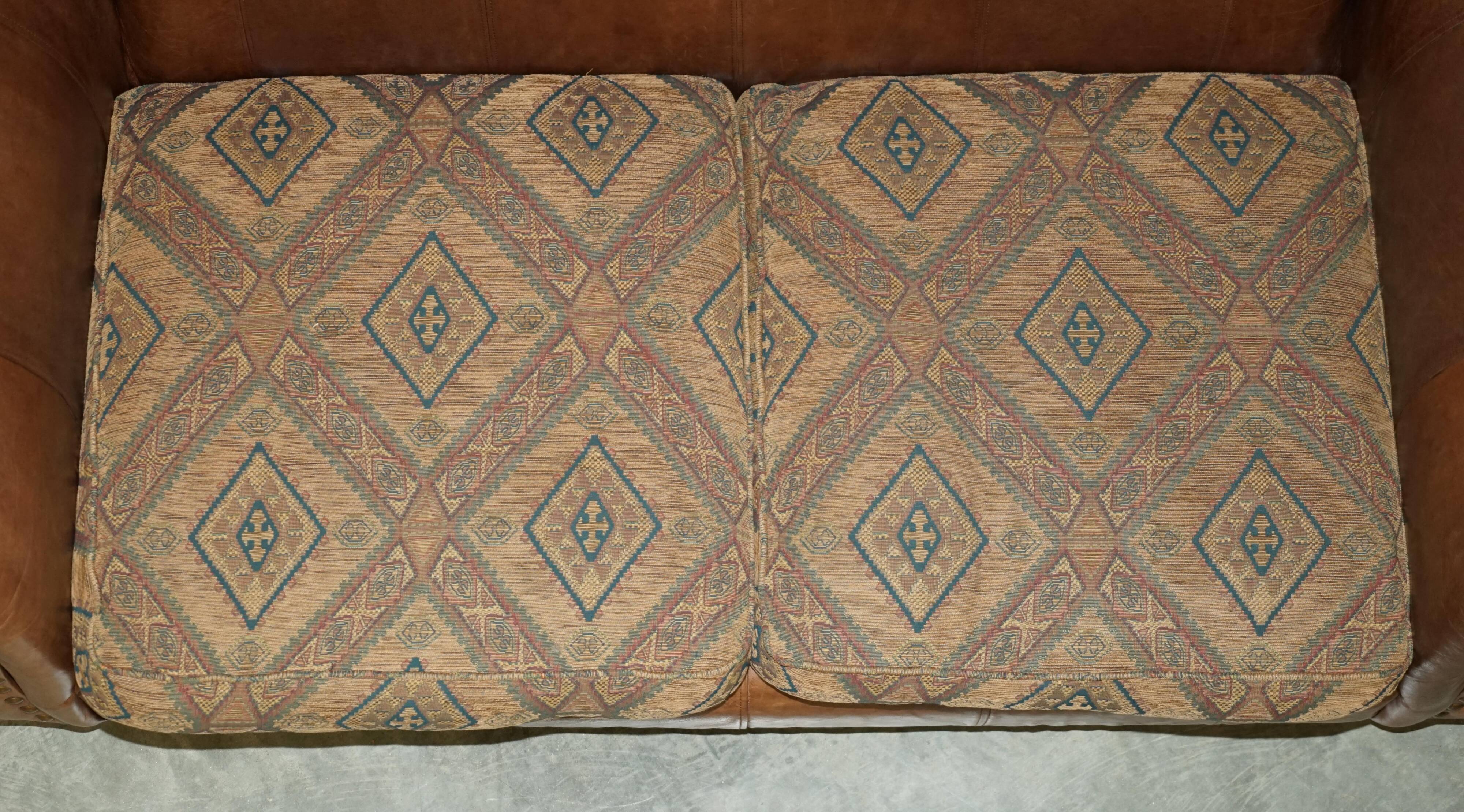 Vintage leather sofas by Thomas Lloyd with Kilim cushions.