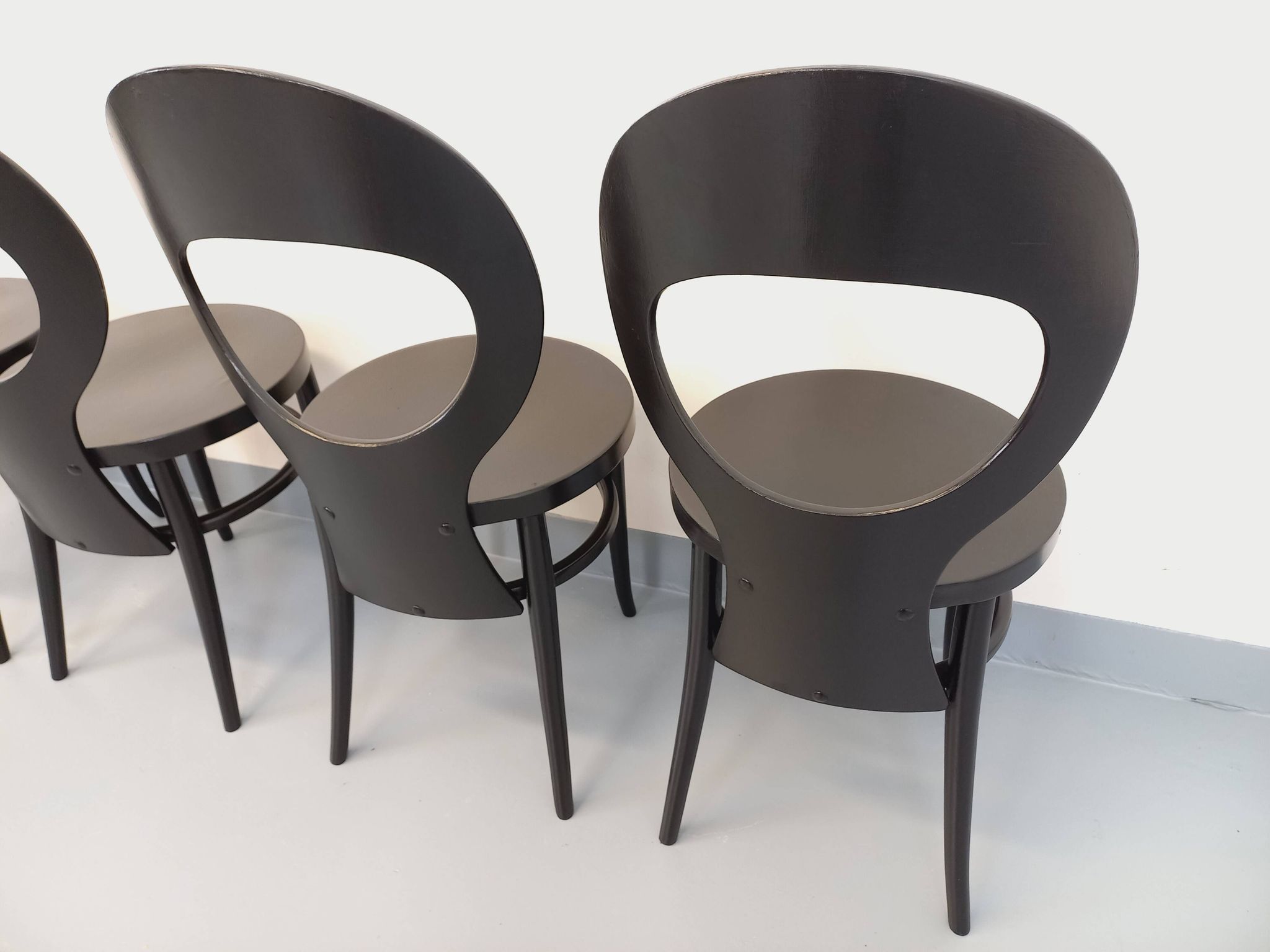 Set of 4 vintage Mouette chairs by Baumann in black wood from the 1960s.