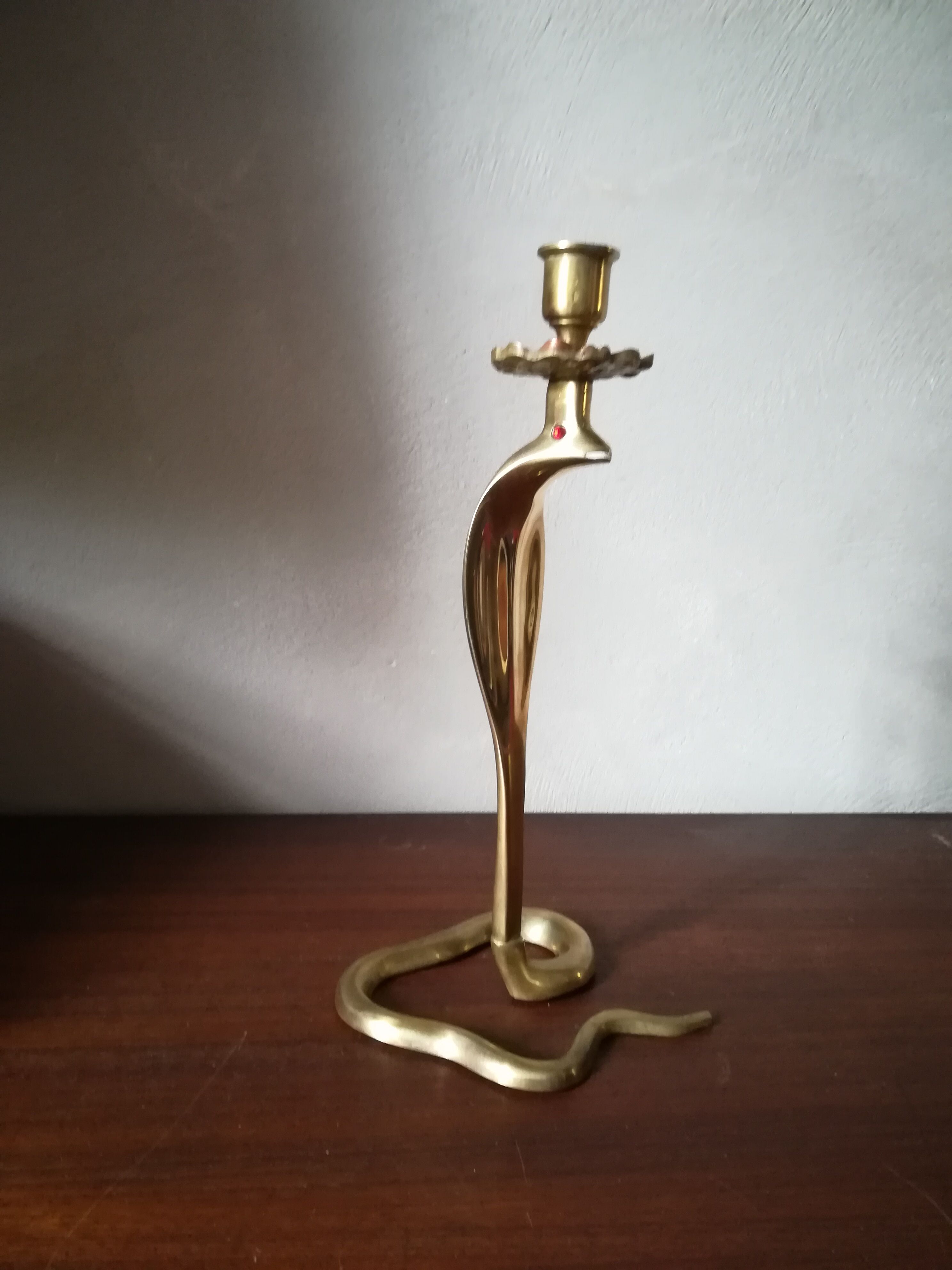 Candlestick mounted on brass cobra