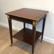 Two-level table in mahogany and brass