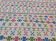 White carpet with Berber motifs pink green and blue
