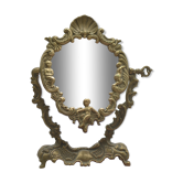 Adjustable psyche mirror of 33 centimeters in gilded bronze with angel ornament
