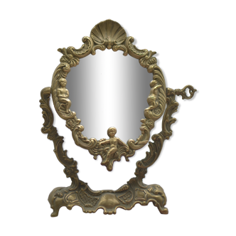 Adjustable psyche mirror of 33 centimeters in gilded bronze with angel ornament