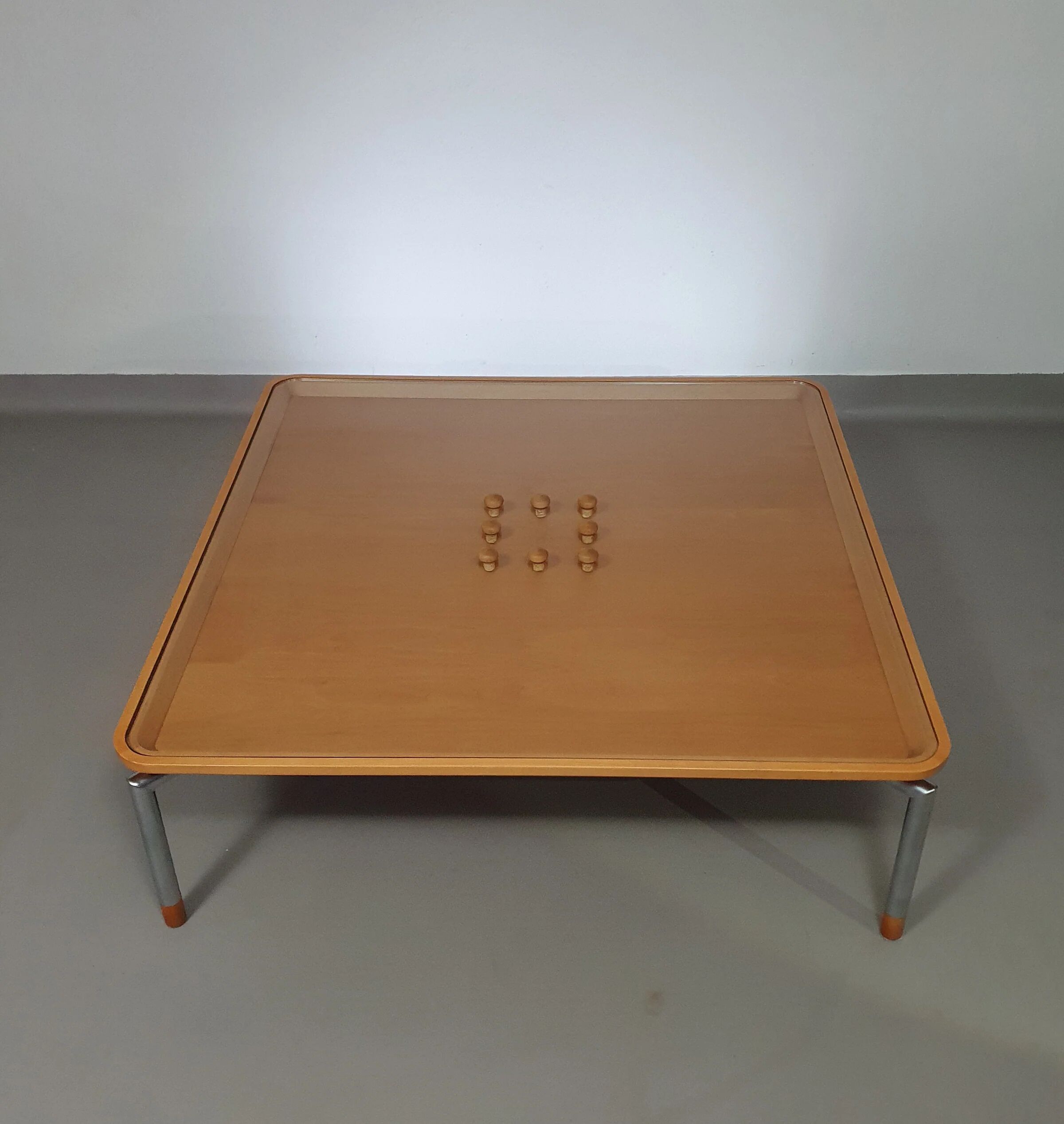 Rare coffee table 110 x 110 x height 35 cm with 8 flange wooden / cork caps in the glass top.