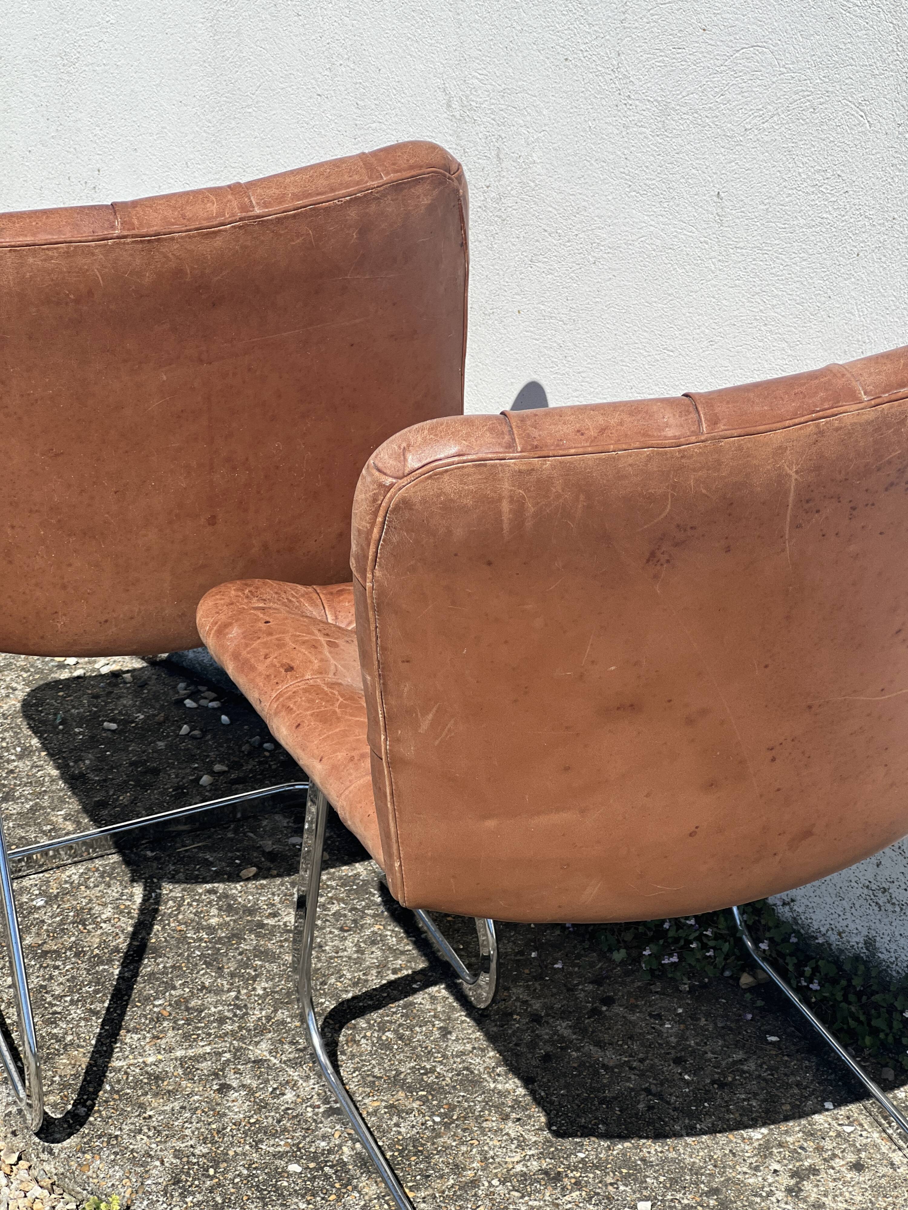 Pair of leather chairs by Robert Haussman
