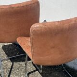 Pair of leather chairs by Robert Haussman