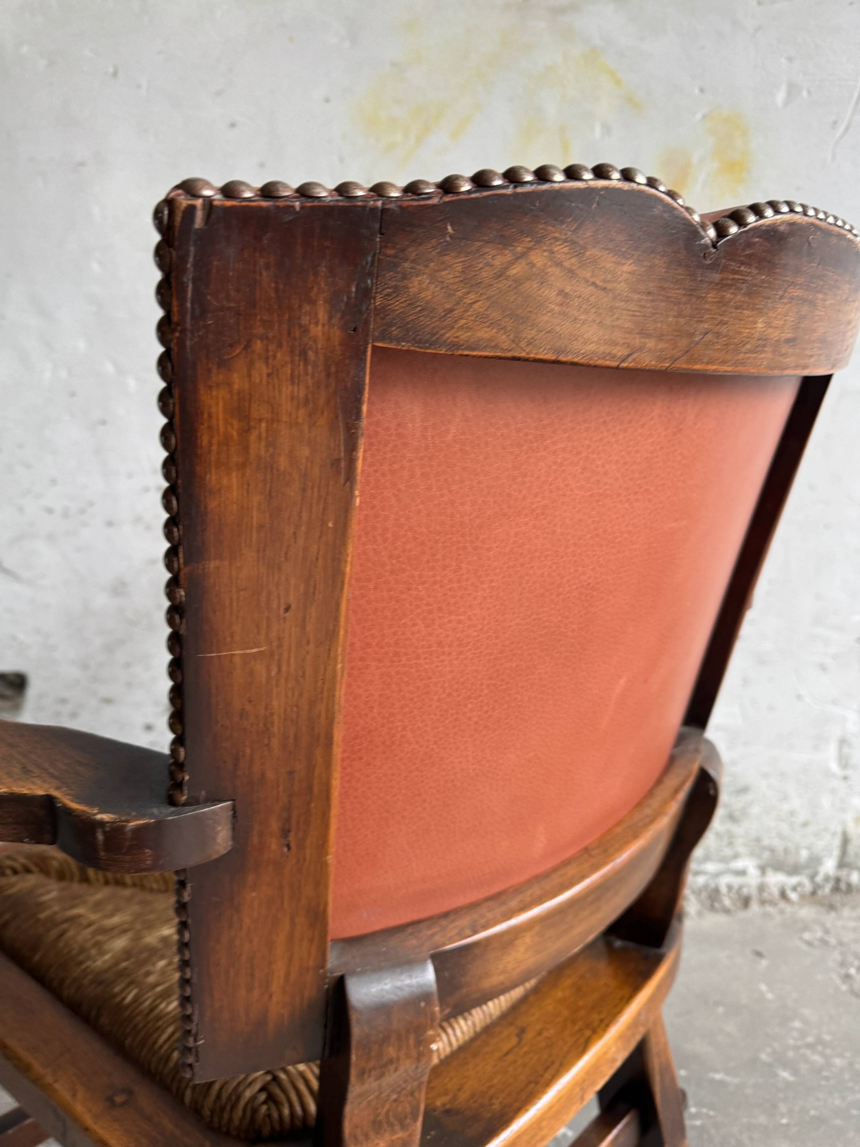 Brutalist dark brown solid wood armchair with natural rattan seat and cognac leather back