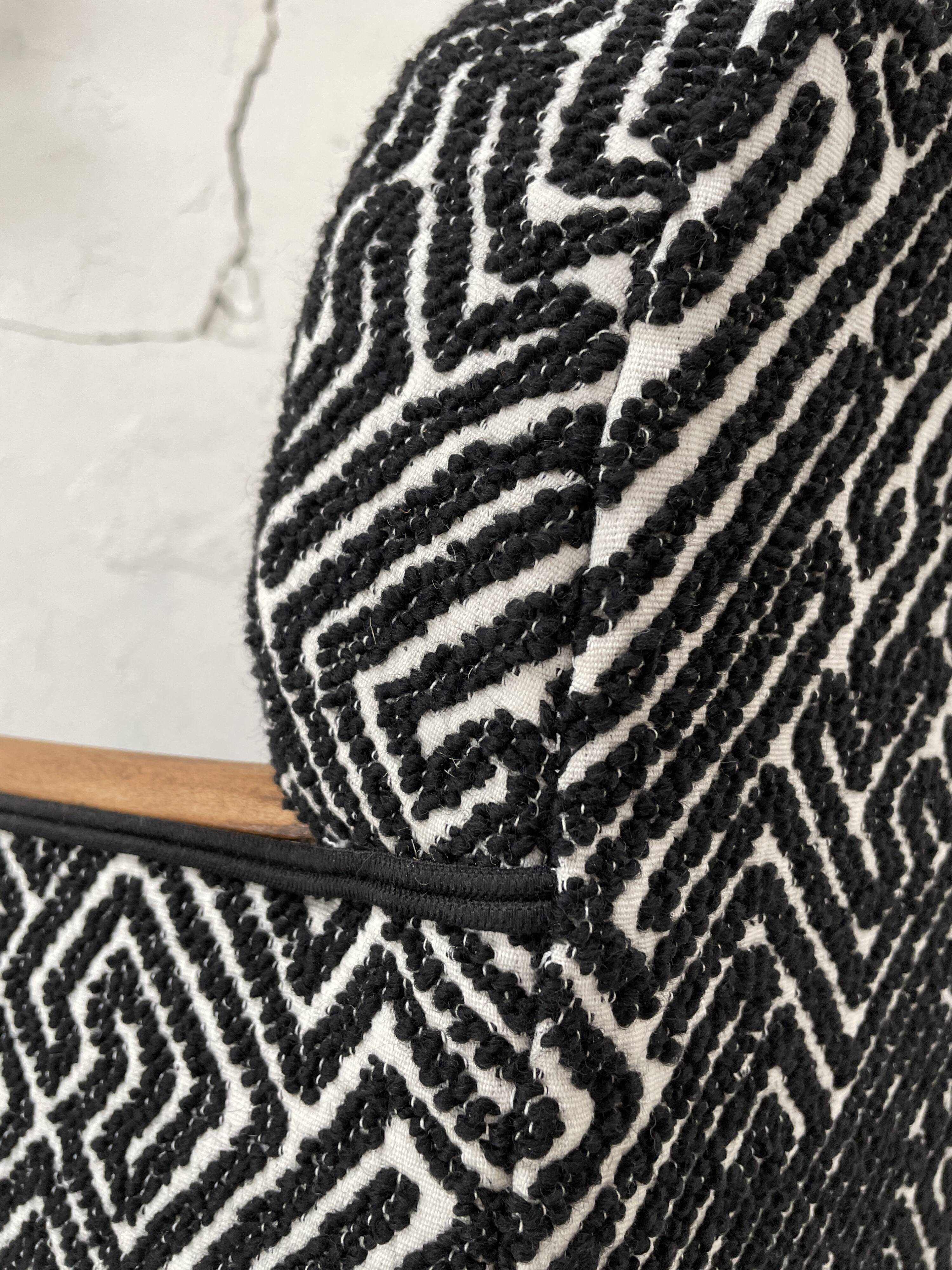 Club armchair in wood and fabric.