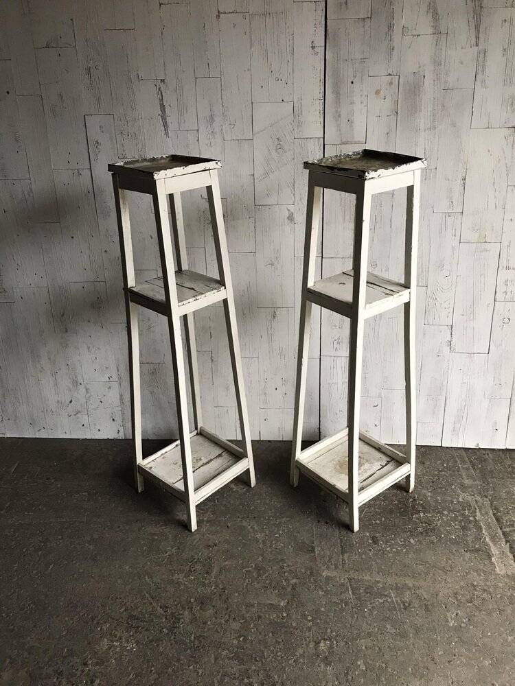 Two white vintage mid-20th century wooden plant stands, 3-tier shelves.