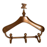 Wall mounted coat rack in the shape of a hanger