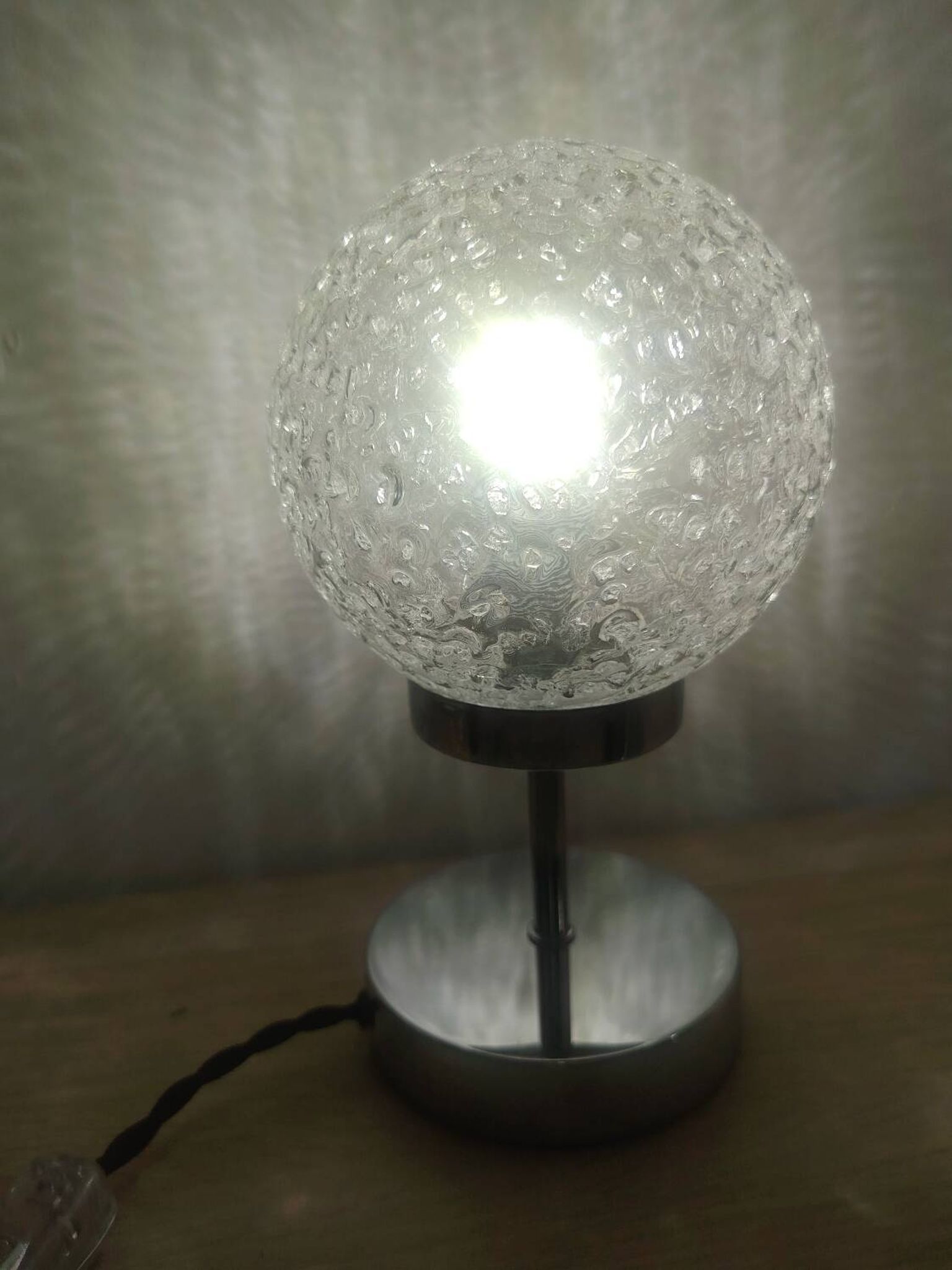 Duo of textured globe lamps with a large play of light.