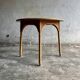 Natural Lloyd Loom paper cord rattan round table with brass-capped legs by Vincent Sheppard