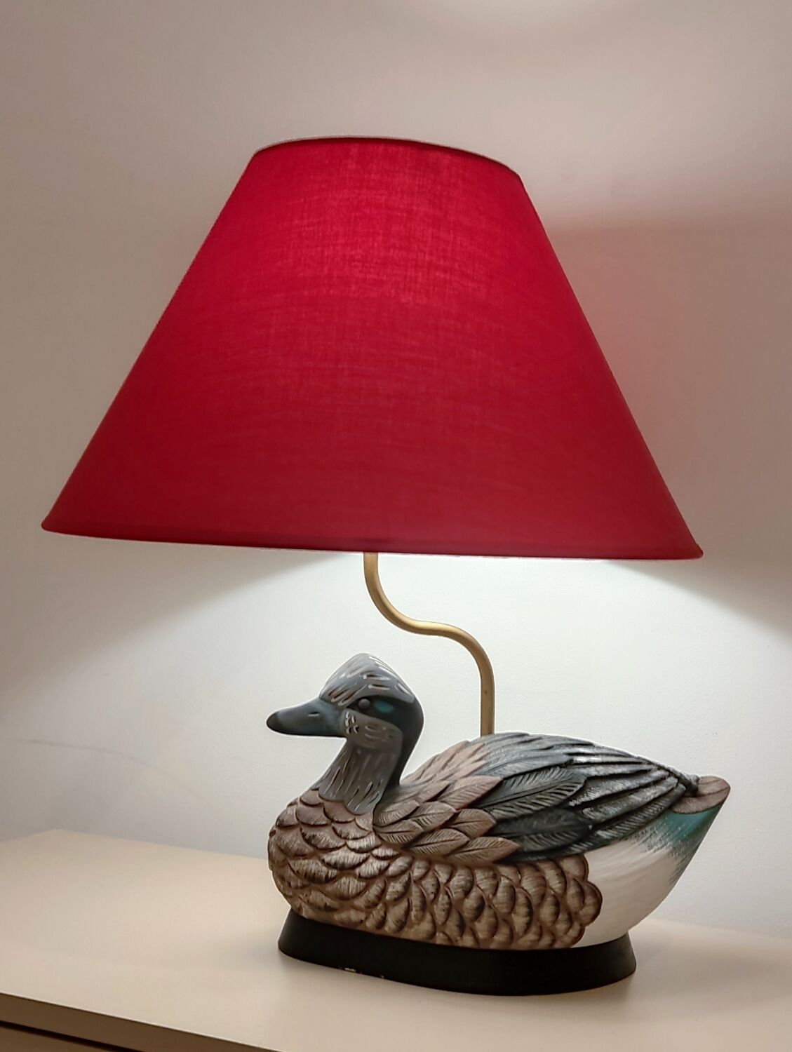 Decorative table lamp with a sculpted duck-shaped base and painted finish.