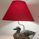 Decorative table lamp with a sculpted duck-shaped base and painted finish.