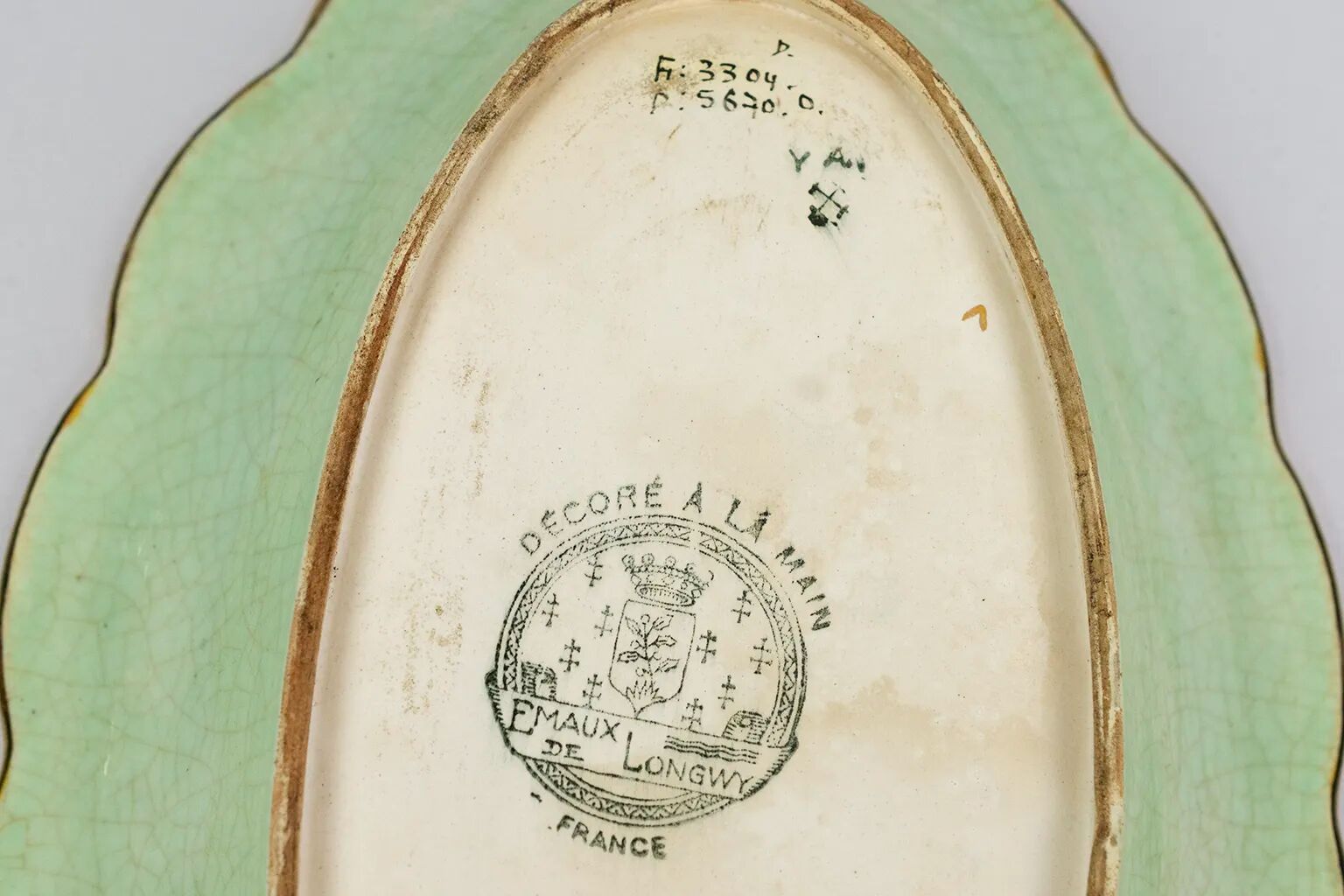 Longwy cup in cloisonné enamels on a green background, polychrome floral decoration and gold