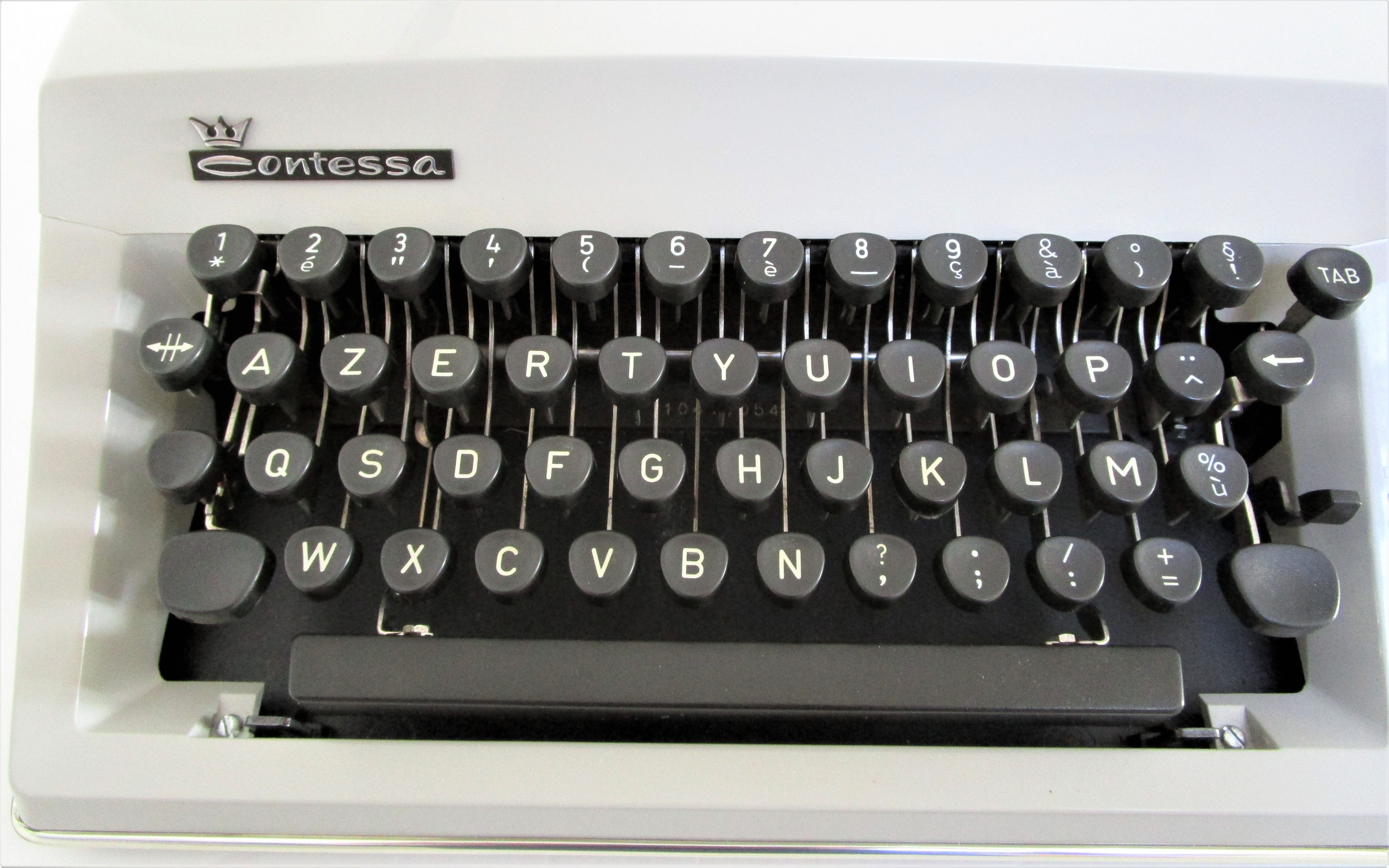 Writers' typewriters of light grey 70s Adler made in Holland