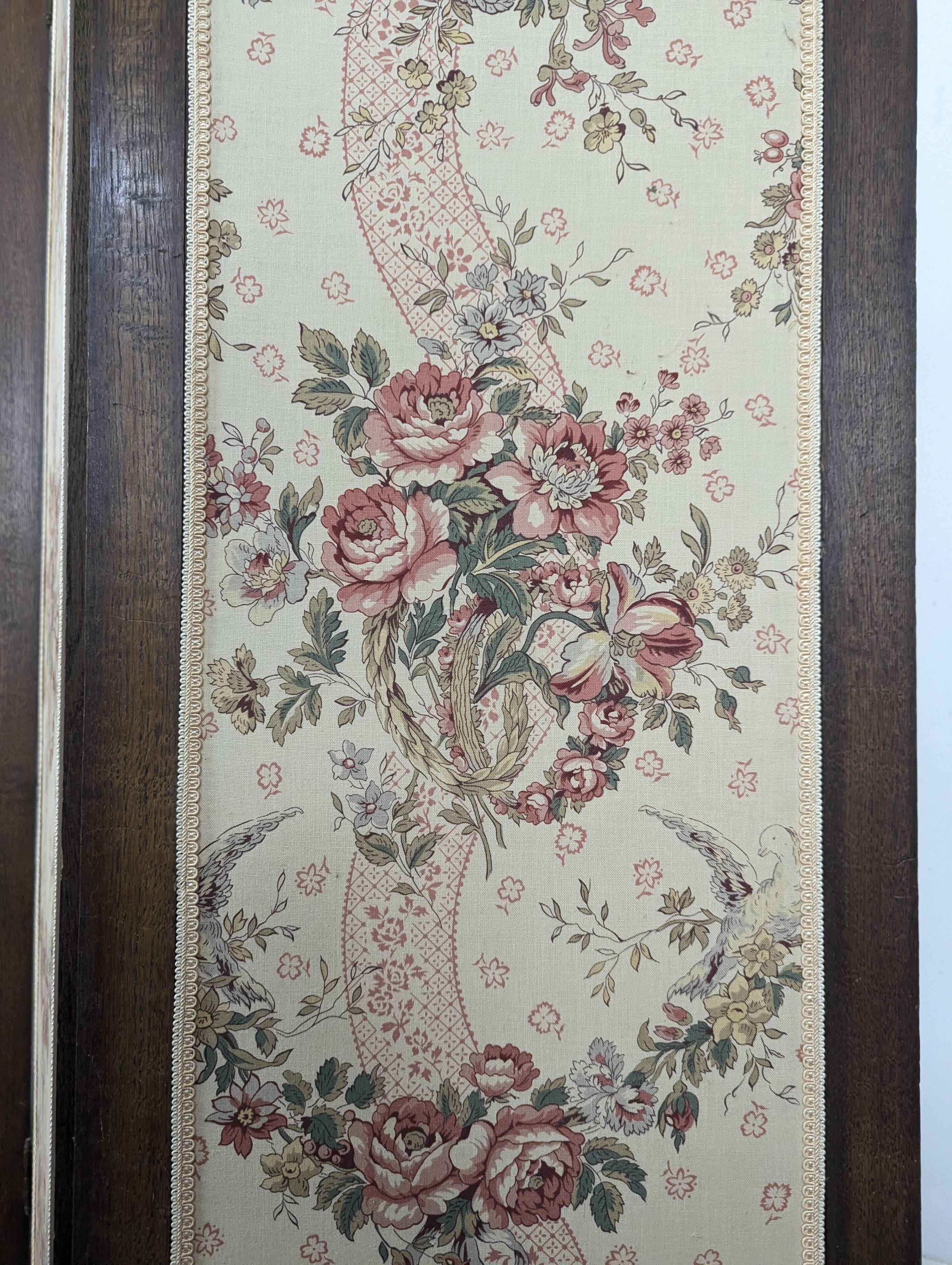 Four-panel oak screen adorned with floral upholstery from the 1930s.