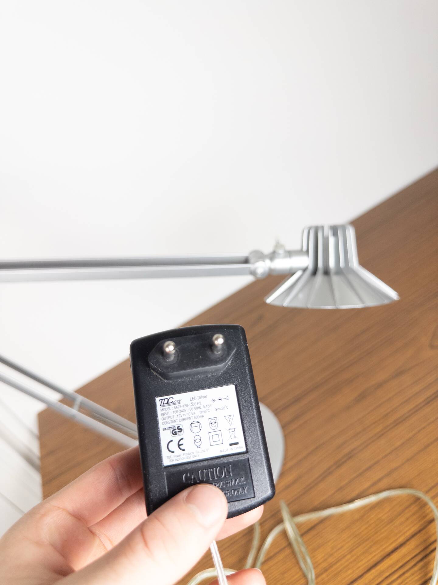 Grey LED architect lamp with spring arm and swivel base.